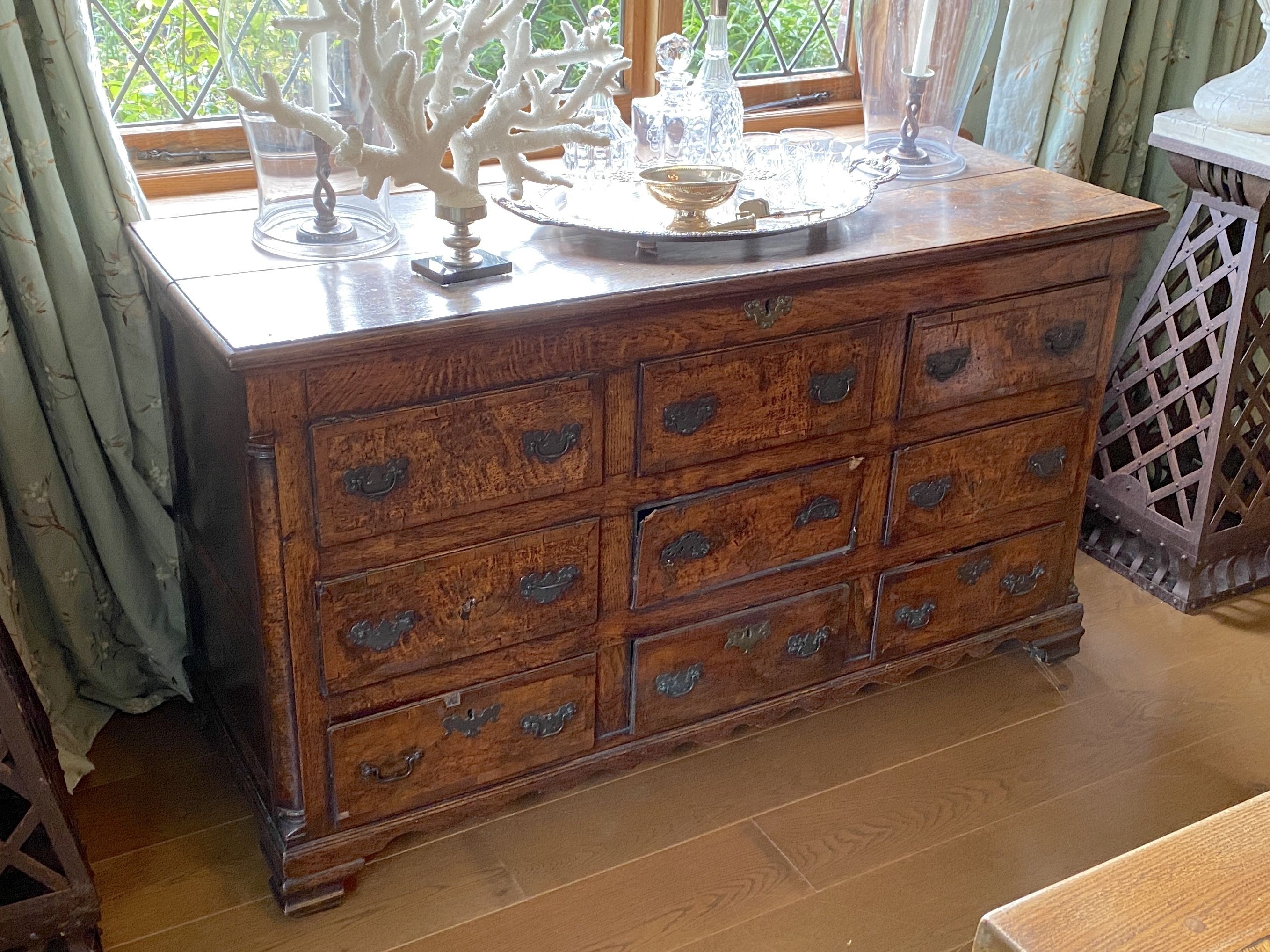 A mid 18th century crossbanded oak mule chest, with rising top and six dummy drawers over three base drawers, on ogee feet, width 155cm depth 57cm height 88cm